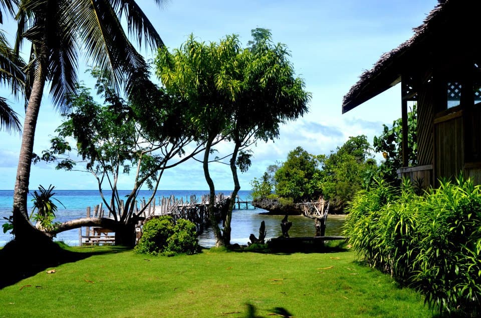Island Retreat – lawn grounds and jetty behind the private beach
