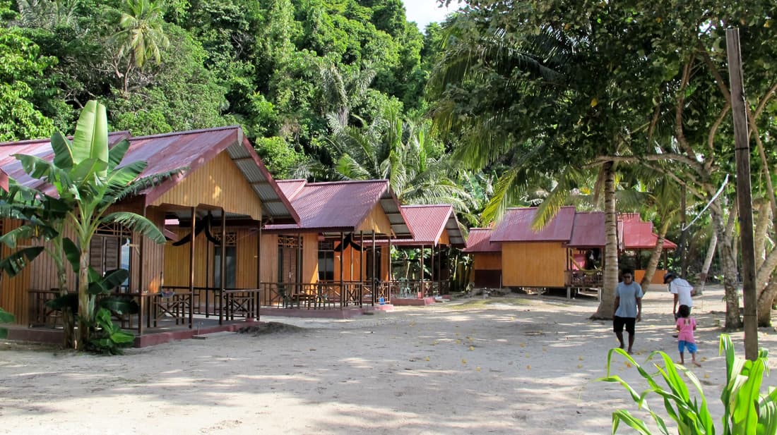 Malenge Indah – row of wooden bungalows along the beach