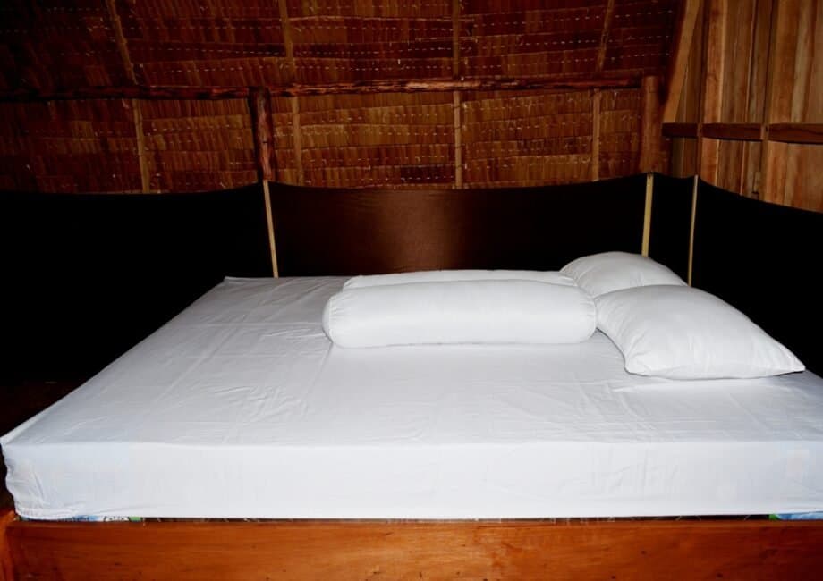 Tanjung Kalemo Resort – bungalow interior with mosquito nets