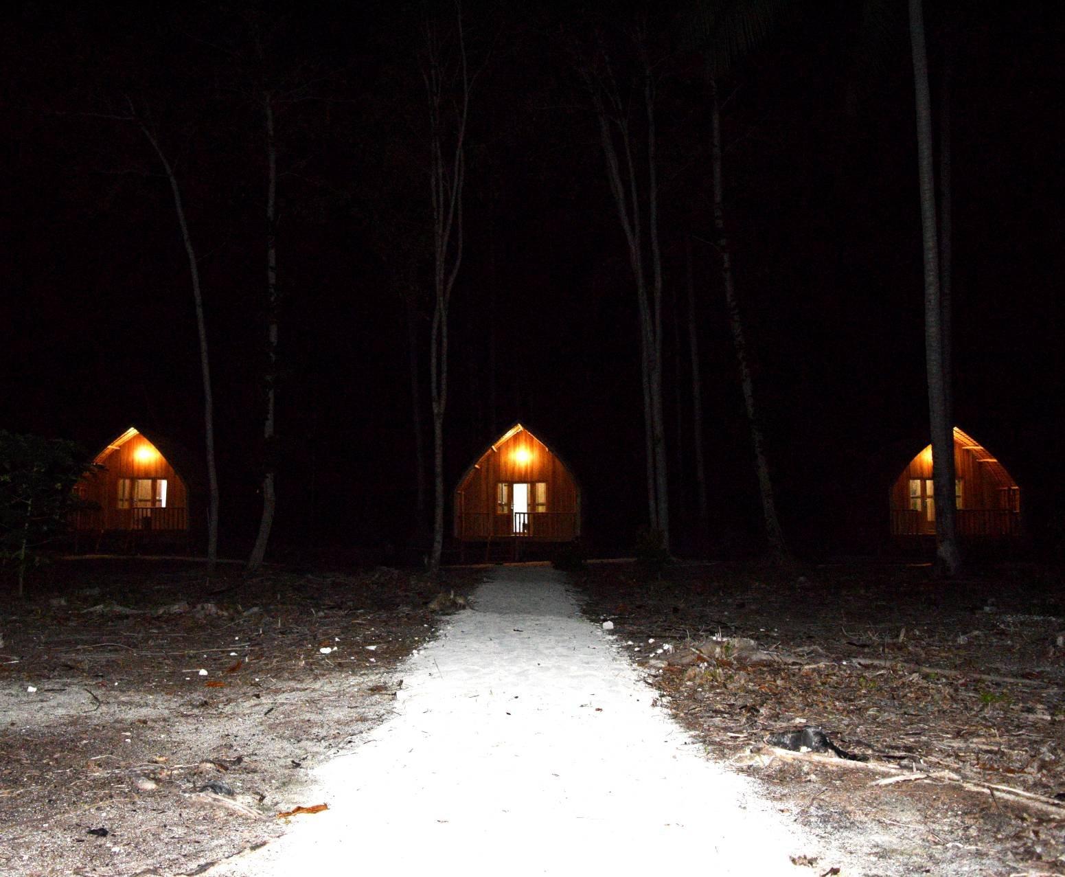 Tanjung Kalemo Resort – bungalows lit at night